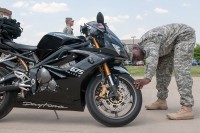 Sgt. 1st Class Guy Taylor, the logistics noncommissioned officer in charge with 101st Special Troops Battalion, 101st Sustainment Brigade, 101st Airborne Division, conducts an inspection on his battle buddies motorcycle during an inspection and training session to kick off the Motorcycle Safety Month on May 6, 2015. (Sgt. 1st Class Mary Rose Mittlesteadt, 101st Sustainment Brigade, 101st Airborne Division Public (Air Assault) Affairs)