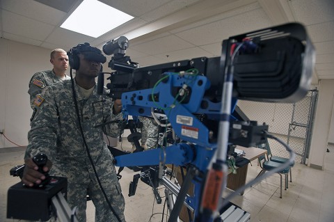 Sgt. Jarrod Stegall, a vehicle crew member with the 626th Brigade Support Battalion, 3rd Brigade Combat Team, 101st Airborne Division, scans for targets during a simulated convoy here July 16, 2015. Stegall conducted training on the 3rd Brigade Combat Team’s unstabilized gunnery trainer-individual, the first of its kind in the active component Army, which allows unit master gunners to build scenarios for crew gunners to virtually engage targets and validate them before conducting live-fire gunnery tables. (Staff Sgt. Joel Salgado, 3rd Brigade Combat Team Public Affairs)