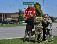 From left, Retired Command Sgt. Maj. Charles Fitzpatrick, Command Sgt Maj. Kenneth Chaney, the senior enlisted operations noncommissioned officer for the 3rd Brigade Combat Team, 101st Airborne Division, Lt. Col. Scott Kirkpatrick, the deputy commander for 3rd BCT, and retired Col. Joe Johnson, pull a WWII parachute from the newly christened Currahee St. sign – formally 35th St. – during the 101st’s Day of the Eagles at Fort Campbell, Ky., July 30, 2015. The street renaming honors the character, courage, competence, and commitment of the men and women of the 506th Infantry Regiment “Currahee” since the regiment’s founding in 1942. (Staff Sgt. Joel Salgado, 3rd Brigade Combat Team Public Affairs)