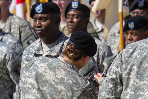 Col. Kimberly J. Daub, commander of the 101st Airborne Division (Air Assault) Sustainment Brigade, places the "Old Abe" 101st Airborne Division patch on Lt. Col. Able E. Young, the commander of the 129th Combat Sustainment Support Battalion, July 30, 2015, at Fort Campbell, Ky. The “Lifeliners” Brigade uncased new colors and donned the division patch in a ceremony to symbolize the brigade’s re-designation as the 101st Airborne Division (Air Assault) Sustainment Brigade. (Spc. Joseph Green, 101st Sustainment Brigade, 101st Airborne Division (Air Assault) Public Affairs)