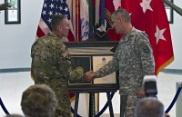 From right: General David M. Rodriguez, commanding general, U.S. Africa Command, and Maj. Gen. Gary J. Volesky, commanding general, 101st Airborne Division (Air Assault) and Fort Campbell, shake hands after unveiling the Joint Meritorious Unit Award during a ceremony at McAuliffe Hall August 27, 2015. (Sgt. William White, 101st Airborne Division Public Affairs)