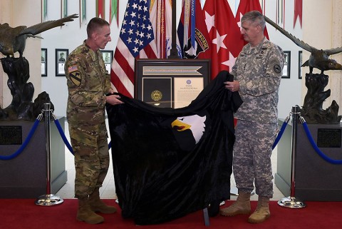 From right: Gen. David M. Rodriguez, commanding general, U.S. Africa Command, and Maj. Gen. Gary J. Volesky, commanding general, 101st Airborne Division (Air Assault) and Fort Campbell, unveil the Joint Meritorious Unit Award during a ceremony at McAuliffe Hall August 27, 2015. (Jerry Woller, Lead VI Specialist-Fort Campbell)