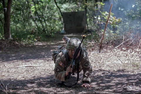 A medic with 3rd Brigade Combat Team, 101st Airborne Division (Air Assault), drops into the prone position during the Expert Field Medical Badge testing here Aug. 1, 2015. The EFMB tests Soldiers' ability to conduct common skills tasks and medical tasks in conditions medics are likely to encounter in the field. Ultimately, only 25 candidates out of more than 185 donned the coveted badge during a ceremony Aug. 6, 2015. (Sgt. Duncan Brennan, 101st Combat Aviation Brigade, 101st Airborne Division Public Affairs)