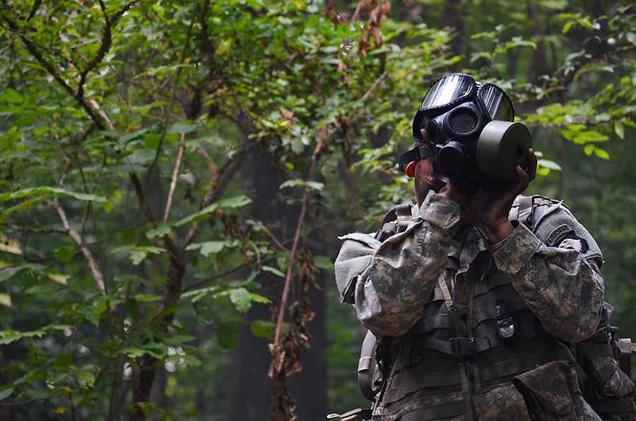 A 1st Brigade Combat Team, 101st Airborne Division (Air Assault) Soldier dons his protective mask while being evaluated during the testing phase of the Expert Field Medical Badge challenge here, Aug. 5, 2015. Chemical, biological, radiological, and nuclear testing is one of the many warrior tasks and drills the medics were evaluated on. (Staff Sgt. Sierra A. Fown, 2nd Brigade Combat Team, 101st Airborne Division Public Affairs)