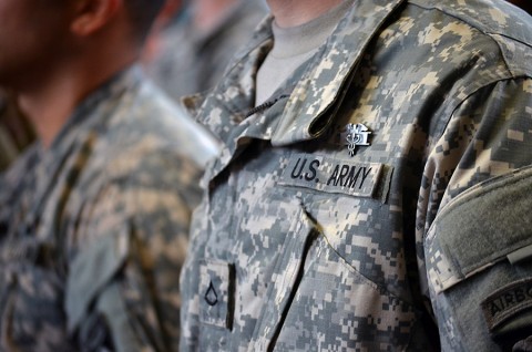 Pfc. Arron R. Juopperi, Headquarters and Headquarters Company, 1st Battalion, 26th Infantry Regiment, 2nd Brigade Combat Team, 101st Airborne Division (Air Assault), stands proudly in formation after being pinned his Expert Field Medical Badge at the Lozado Physical Fitness Center here, Aug. 6, 2015. The Expert Field Medical Badge has a 15 percent success rate amongst its potential candidates. (Staff Sgt. Sierra A. Fown, 2nd Brigade Combat Team, 101st Airborne Division Public Affairs)