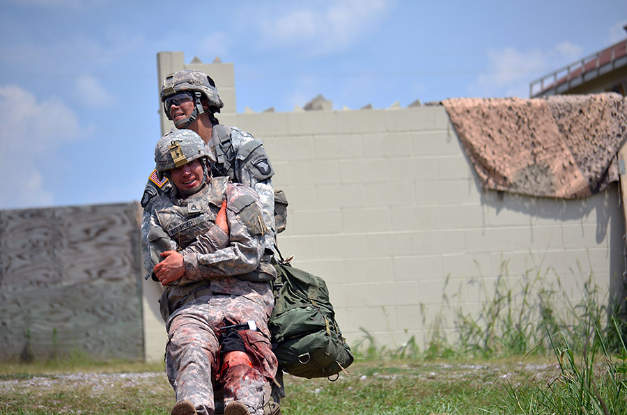 Sgt. Alisa Ryder, Company C, 526th Brigade Support Battalion, 2nd Brigade Combat Team, 101st Airborne Division (Air Assault), performs a one-man carry while being evaluated during the testing phase of the Expert Field Medical Badge challenge here, Aug. 4, 2015. Tactical combat casualty care is one of the many requirements medical personnel need to be proficient in in order to pass the evaluation. (Staff Sgt. Sierra A. Fown, 2nd Brigade Combat Team, 101st Airborne Division Public Affairs)