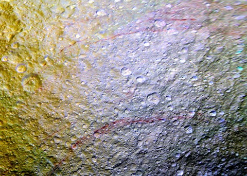 Unusual arc-shaped, reddish streaks cut across the surface of Saturn's ice-rich moon Tethys in this enhanced-color mosaic. The red streaks are narrow, curved lines on the moon's surface, only a few miles (or kilometers) wide but several hundred miles (or kilometers) long. (NASA/JPL-Caltech/Space Science Institute)