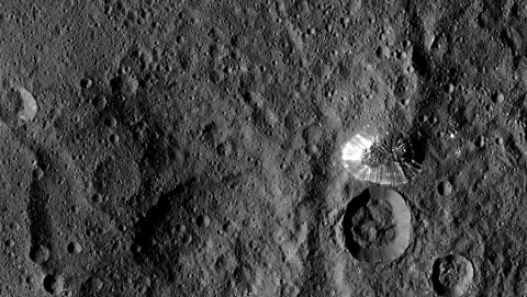 NASA's Dawn spacecraft spotted this tall, conical mountain on Ceres from a distance of 915 miles (1,470 kilometers). The mountain, located in the southern hemisphere, stands 4 miles (6 kilometers) high. Its perimeter is sharply defined, with almost no accumulated debris at the base of the brightly streaked slope. (NASA/JPL-Caltech/UCLA/MPS/DLR/IDA)