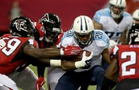 Tennessee Titans running back Bishop Sankey (20) gets tackled by Atlanta Falcons linebacker Joplo Bartu (59) and others in the   first quarter of their preseason NFL football game at Georgia Dome. (Jason Getz-USA TODAY Sports)