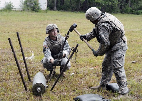 During the 2014 Explosive Ordnance Disposal Team of the Year competition at Fort A.P. Hill, Soldiers from the 732nd EOD Company, 52nd Ord. Group, Fort Campbell, Ky., secure an inert bomb to ensure it will not move during diffusing procedures. It was one of 14 tasks teams were asked to perform during the competition. (Courtesy Photo)