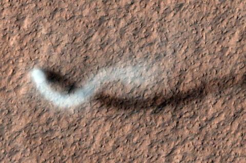 A towering dust devil casts a serpentine shadow over the Martian surface in this image acquired by the High Resolution Imaging Science Experiment (HiRISE) camera on NASA's Mars Reconnaissance Orbiter.The scene is a late-spring afternoon in the Amazonis Planitia region of northern Mars. (NASA/JPL-Caltech/University of Arizona)