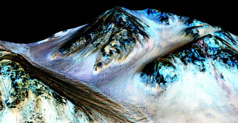 Dark, narrow streaks on Martian slopes such as these at Hale Crater are inferred to be formed by seasonal flow of water on contemporary Mars. The streaks are roughly the length of a football field. (NASA/JPL-Caltech/Univ. of Arizona)