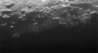 Near-Surface Haze or Fog on Pluto: In this small section of the larger crescent image of Pluto, taken by NASA’s New Horizons just 15 minutes after the spacecraft’s closest approach on July 14, 2015, the setting sun illuminates a fog or near-surface haze, which is cut by the parallel shadows of many local hills and small mountains. (NASA/JHUAPL/SwRI)