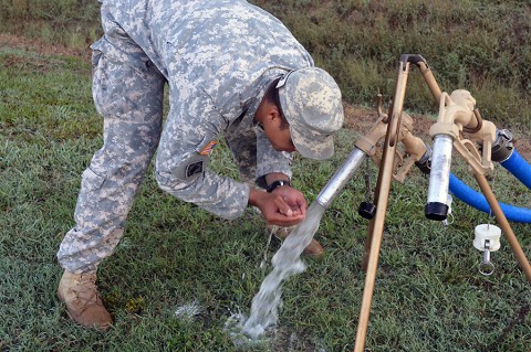 Spc. Deaughn Clinton, a petroleum supply specialist with the 129th Combat Sustainment Support Battalion, 101st Airborne Division Sustainment Brigade, samples newly-purified stream water at the intermediate staging base at the Joint Readiness Training Center, Fort Polk, La., Sept. 23, 2015. (Maj. Ireka Sanders, 2nd Brigade Combat Team, 101st Airborne Division (Air Assault) Public Affairs)