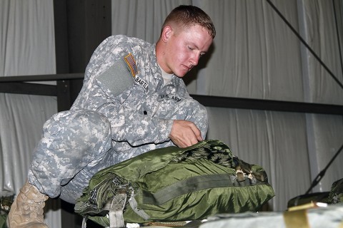 Spc. Wylie Bartling with the 372nd Inland Cargo Transfer Company, 129th Combat Sustainment Support Battalion, 101st Airborne Division Sustainment Brigade prepares an aerial delivery bundle Sept. 30, 2015, at England Airfield in Alexandria, La. Delivery bundles will ensure Soldiers, with the 2nd Brigade Combat Team, 101st Airborne Division (Air Assault), in training areas receive supplies to conduct various missions for Soldier readiness and mission success during their Joint Readiness Training Center rotation at Fort Polk, LA. (Sgt. 1st Class Mary Rose Mittlesteadt, 101st Airborne Division Sustainment Brigade public affairs)