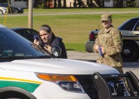 Officer Shelby Nelson with the Clarksville Police Department, provides cover for Sgt. John Michl, a military police officer with the 551st Military Police Company, 716th Military Police Battalion, 101st Airborne Division Sustainment Brigade, 101st Airborne Division (Air Assault), from behind a Montgomery County Sherriff’s Office vehicle during the approaches and breaching portion of the Advanced Law Enforcement Rapid Reaction Training train-the-trainer active shooter course Oct. 14, 2015, at Fort Campbell, KY. (Spc. Joseph Green, 101st Sustainment Brigade, 101st Airborne Division (AA) Public Affairs)