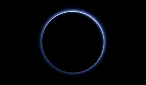 Pluto’s Blue Sky: Pluto’s haze layer shows its blue color in this picture taken by the New Horizons Ralph/Multispectral Visible Imaging Camera (MVIC). The high-altitude haze is thought to be similar in nature to that seen at Saturn’s moon Titan. The source of both hazes likely involves sunlight-initiated chemical reactions of nitrogen and methane, leading to relatively small, soot-like particles (called tholins) that grow as they settle toward the surface. (NASA/JHUAPL/SwRI) Pluto’s Blue Sky: Pluto’s haze layer shows its blue color in this picture taken by the New Horizons Ralph/Multispectral Visible Imaging Camera (MVIC). The high-altitude haze is thought to be similar in nature to that seen at Saturn’s moon Titan. The source of both hazes likely involves sunlight-initiated chemical reactions of nitrogen and methane, leading to relatively small, soot-like particles (called tholins) that grow as they settle toward the surface. (NASA/JHUAPL/SwRI)