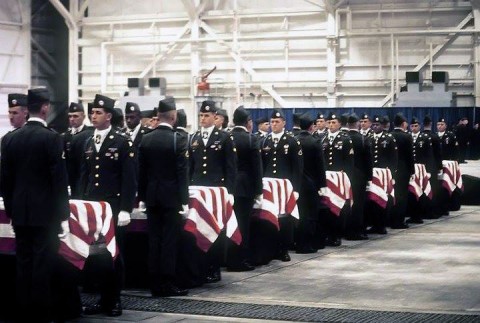 Soldiers from 2nd Brigade Combat Team, 101st Airborne Division (Air Assault), carry the remains of the 248 101st Soldiers who perished in the crash of Arrow Air Flight 1285, Dec. 12, 1985, near Gander International Airport in Newfoundland, Canada. Amy Gallo’s late husband, Sgt. Richard S. Nichols, remains are in the third coffin from the left. (Courtesy Photo)