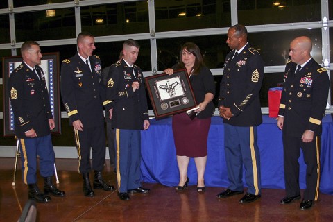 Blanchfield Army Community Hospital medic Staff Sgt. Travis Lander is one of 16 combat medics to be recognized Oct. 29 at the Wilma Rudolph Events Center in Clarksville, Tenn., during the 6th Annual Angels of the Battlefield ceremony. Pictured left to right: 101st Airborne Division Command Sgt. Maj. Gregory F. Nowak; 101st Airborne Division commanding general Maj. Gen. Gary J. Volesky; Blanchfield Army Community Hospital medic Staff Sgt. Travis Lander; Fort Campbell Armed Services YMCA director Karen Grimsley; Healthcare Operations Division for Defense Health Agency Sgt. Maj. Paul Ambersley; and Healthcare Operations for the Defense Health Agency director Maj. Gen. Richard W. Thomas.