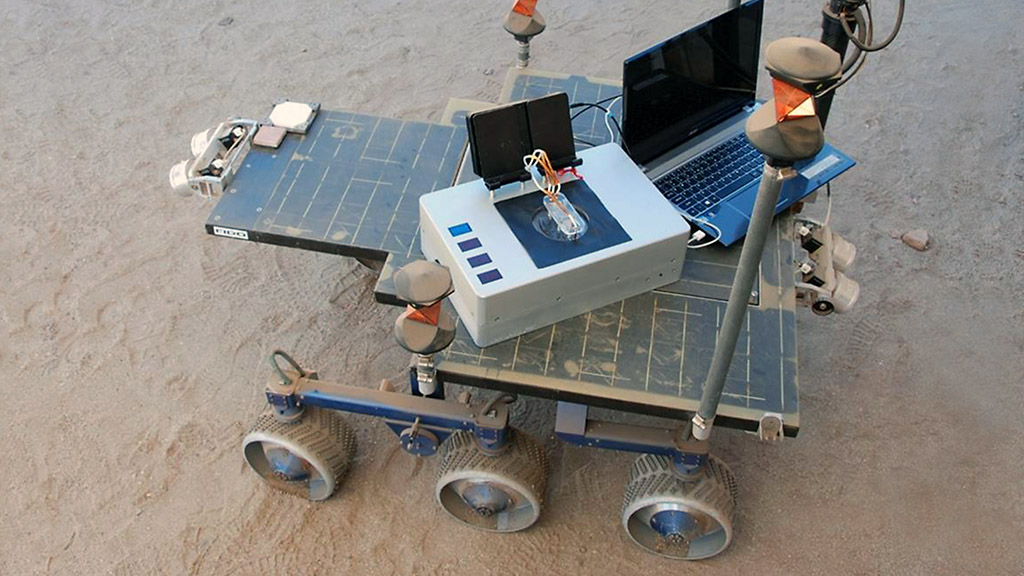 Researchers took the Chemical Laptop to JPL's Mars Yard, where they placed the device on a test rover. This image shows the size comparison between the Chemical Laptop and a regular laptop. (NASA/JPL-Caltech) Researchers took the Chemical Laptop to JPL's Mars Yard, where they placed the device on a test rover. This image shows the size comparison between the Chemical Laptop and a regular laptop. (NASA/JPL-Caltech)