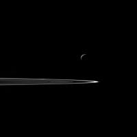 Following a successful close flyby of Enceladus, NASA's Cassini spacecraft captured this artful composition of the icy moon with Saturn's rings beyond. (NASA/JPL-Caltech/Space Science Institute)