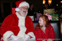 Santa Claus visiting with a little girl after the parade.