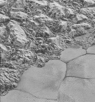 The Mountainous Shoreline of Sputnik Planum: In this highest-resolution image from NASA’s New Horizons spacecraft, great blocks of Pluto’s water-ice crust appear jammed together in the informally named al-Idrisi mountains. (NASA/JHUAPL/SwRI)