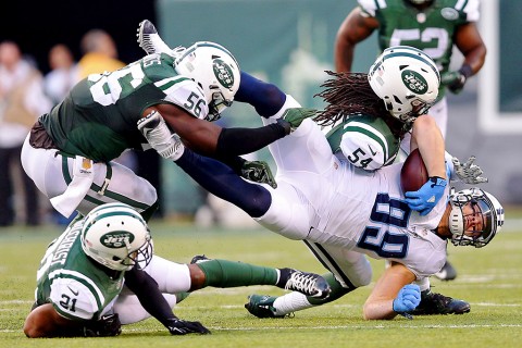 Tennessee Titans tight end Phillip Supernaw (89) is tackled by New York Jets linebacker Jamari Lattimore (54) and linebacker Demario Davis (56) and safety Marcus Gilchrist (21) during the fourth quarter at MetLife Stadium. The Jets defeated the Titans 30-8. (Brad Penner-USA TODAY Sports)