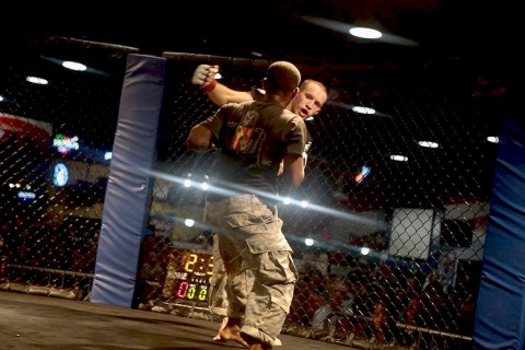 Spc. Christian L. Nielsen, 1st Battalion, 502nd Infantry Regiment, 2nd Brigade Combat Team, 101st Airborne Division, punches an opponent during the 2015 All-Armed Forces Combatives Competition at Fort Bragg, NC, Dec. 12, 2015. Nielsen took home 1st place for the second year in a row. (Courtesy Photo)