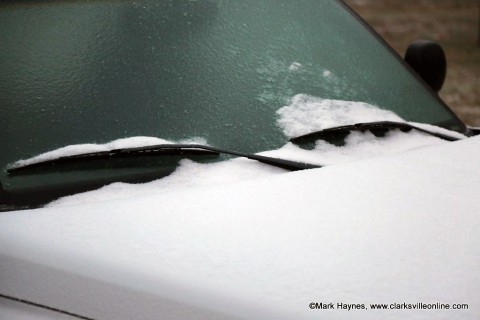 Vehicles left outside are covered in ice.