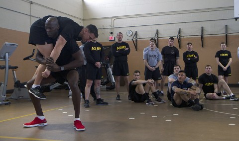 Staff Sgt. William Webb, a Master Fitness Trainer Course instructor, lifts Staff Sgt. John Wood, also an instructor, during a demonstration of the Soldier carry at an MFTC at Fort Campbell, Ky., Jan. 26, 2016. The instructors are part of a mobile training team that travels to Army posts to teach Soldiers phase two of the MFTC over a two-week period. (Sgt. William White, 101st Airborne Division Public Affairs)