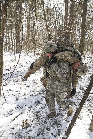 Sgt. Jaden Glossup, 1st squad alpha team leader, 2nd platoon, Able Company, 1st Battalion, 506th Infantry Regiment, 1st Brigade Combat Team, 101st Airborne Division (Air Assault) is buddy carried by Spc. Tyler Pimanis, 1st squad bravo team leader, 2nd platoon, during a training exercise when Glossup was notionally wounded February 10, 2016. (Sgt. Samantha Stoffregen, 1st Brigade Combat Team, 101st Airborne Division (Air Assault) Public Affairs)