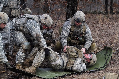 Medics with Company C, 1st Battalion, 327th Infantry Regiment, 1st Brigade Combat Team, 101st Airborne Division (Air Assault) move a notionally injured Soldier to a litter during the live fire exercise Feb. 17, 2016, at Range 55, Fort Campbell, KY. (Sgt. Samantha Stoffregen, 1st Brigade Combat Team, 101st Airborne Division (Air Assault) Public Affairs)