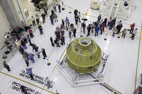 Inside the Neil Armstrong Operations and Checkout Building high bay at NASA's Kennedy Space Center in Florida, members of the news media get an up-close look at the Orion crew module pressure vessel on Feb. 3. Testing and assembly has begun, which will lead to Exploration Mission-1 in 2018. EM-1 will be an uncrewed flight test in which the spacecraft will launch atop NASA’s Space Launch System rocket. (NASA/Bill White)