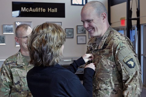 Lt. Col. Cory Mulhern, a liaison officer for the 101st Airborne Division (Air Assault), smiles at his daughter, Sierra, as she pins on his rank during his promotion ceremony in the division headquarters, Fort Campbell, Ky., Feb. 11, 2016. (Sgt. 1st Class Nathan Hoskins 101st Airborne Division Public Affairs)