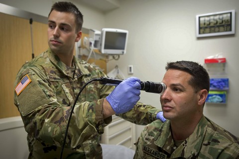 In a demonstration of the Telehealth process at Fort Campbell’s Blanchfield Army Community Hospital, clinical staff nurse 1st Lt. Maxx P. Mamula examines mock patient Master Sgt. Jason H. Alexander using a digital external ocular camera. The image is immediately available to Lt. Col. Kevin A. Horde, a provider at Fort Gordon’s Eisenhower Medical Center, offering remote consultation. (U.S. Army photo by David E. Gillespie)