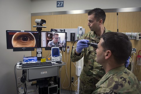 In a demonstration of the Telehealth process at Fort Campbell’s Blanchfield Army Community Hospital, clinical staff nurse Lt. Maxx P. Mamula examines mock patient Master Sgt. Jason H. Alexander using a digital external ocular camera. The image is immediately available to Lt. Col. Kevin A. Horde, a provider at Fort Gordon’s Eisenhower Medical Center, offering remote consultation. (U.S. Army photo by David E. Gillespie)