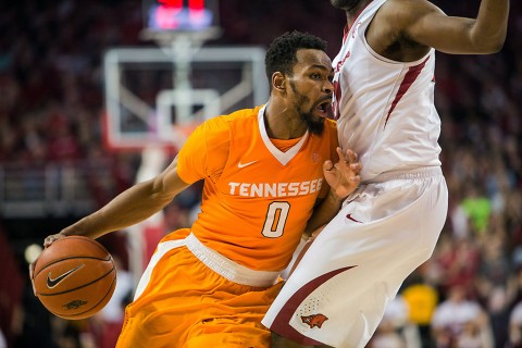 Tennessee Volunteers guard Kevin Punter Jr. (0) dribbles into Arkansas Razorbacks forward Moses Kingsley (33) during the second half of play at Bud Walton Arena. The Razorbacks won 85-67. (Gunnar Rathbun-USA TODAY Sports)