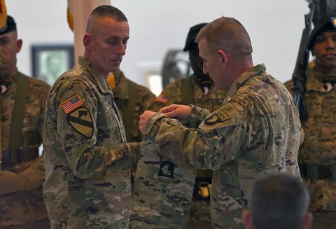 Maj. Gen. Gary J. Volesky (left), 101st Airborne Division (Air Assault) commanding general, and Command Sgt. Maj. Gregory F. Nowak (right), 101st Airborne Division command sergeant major, case the storied 101st colors Feb. 25, during a ceremony officially marking the division's deployment to Iraq in support of Operation Inherent Resolve. (Sgt. William White, 101st Airborne Division Public Affairs)