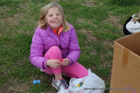 Mattie Britt opening her Easter Eggs.