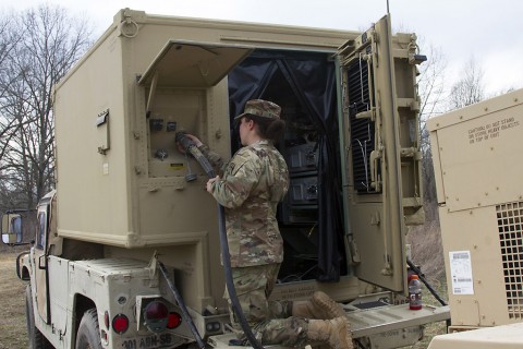 Spc. Jaclyn Fagan, a connects the Join Network Nod to the generator in order to give it power and be able to provide her command team with reliable voice and video communication during a field training exercise on Fort Campbell, Ky., March 17, 2016. (U.S. Army Sgt. Neysa Canfield, 101st Sustainment Brigade Public Affairs)