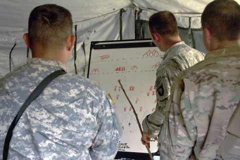 Capt. Patrick Franks, the 58th Signal Company, 101st Special Troops Battalion, 101st Sustainment Brigade, 101st Airborne Division (Air Assault), goes over tactical movements and the what the roles each Soldier entails during a field training exercise on Fort Campbell, Ky., March 17, 2016.(U.S. Army Sgt. Neysa Canfield, 101st Sustainment Brigade Public Affairs)