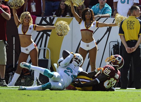 Miami Dolphins defensive back Brice McCain (24) intercepts a pass over Washington Redskins wide receiver Pierre Garcon (88) during the second half at FedEx Field on September 13th 2015. (Brad Mills-USA TODAY Sports)