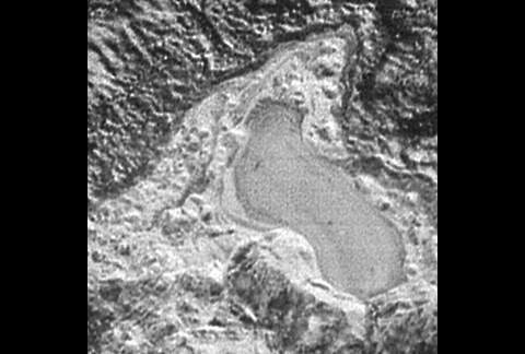 Former frozen lake of nitrogen found near mountain range on Pluto. (NASA/JHUAPL/SwRI)