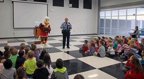 School Resource Officer Jim Knoll assisted Eddie in teaching a class on gun safety to children at Carmel Elementary School.