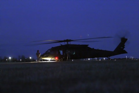 Crew chiefs with Alpha Company, 2nd Battalion (Assault), 10th Aviation Brigade, 10th Mountain Division, wait for Soldiers to begin loading onto the UH-60 Black Hawk during the night air assault Feb. 28, 2016, on Fort Campbell, Ky. The “Voodoo” crew chiefs assisted 1st Battalion, 506th Infantry Regiment, 1st Brigade Combat Team, 101st Airborne Division (Air Assault) during the battalion air assault, a mission conducted during the brigade’s field exercise. (Sgt. Samantha Stoffregen, 1st Brigade Combat Team, 101st Airborne Division (Air Assault) Public Affairs)