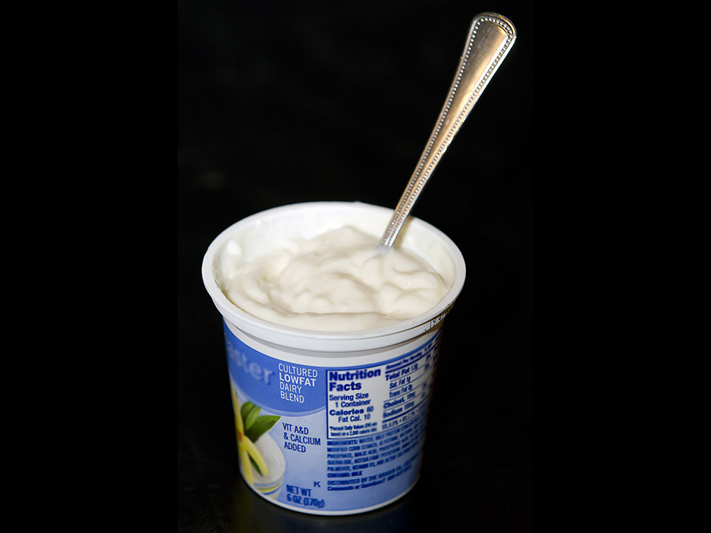 Yogurt LowFat plain in cup with spoon verticle. (American Heart