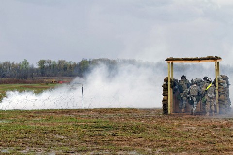 Soldiers from 101st Human Resource Company, 101st Special Troops Battalion, 101st Sustainment Brigade, 101st Airborne Division (Air Assault), are taken by surprise when the opposing forces uses smoke to conceal themselves during the battalions defense live fire exercise on Fort Campbell, Ky., March 31, 2016. (U.S. Army Sgt. Neysa Canfield, 101st Sustainment Brigade Public Affairs)