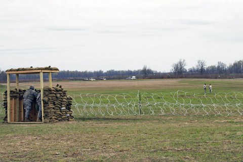 Soldiers from the 101st Special Troops Battalion, 101st Sustainment Brigade, 101st Airborne Division (Air Assault), watch their sectors as opposing forces, played by role players, attempt to enter their base during the battalions defense live fire exercise on Fort Campbell, Ky., March 30, 2016. (U.S. Army Sgt. Neysa Canfield, 101st Sustainment Brigade Public Affairs)