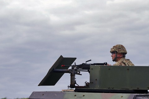 Spc. Stephen M. Dias, an Information technology specialist with the 101st Financial Management Support Unit, 101st Sustainment Brigade, 101st Airborne Division (Air Assault), is the Humvee gunner for his platoon and he watches his sector carefully during the battalions defense live fire exercise on Fort Campbell, Ky., March 30, 2016. (U.S. Army Sgt. Neysa Canfield, 101st Sustainment Brigade Public Affairs)